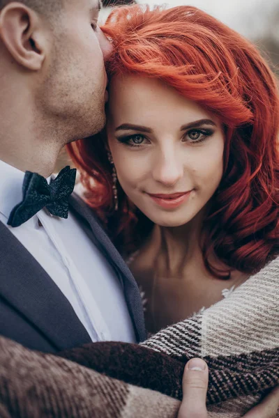 Groom and bride in blanket — Stock Photo, Image