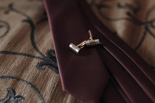 Golden cufflinks on red tie — Stock Photo, Image