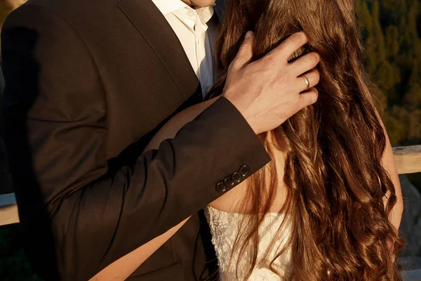 Happy stylish groom hugging bride — Stock Photo, Image
