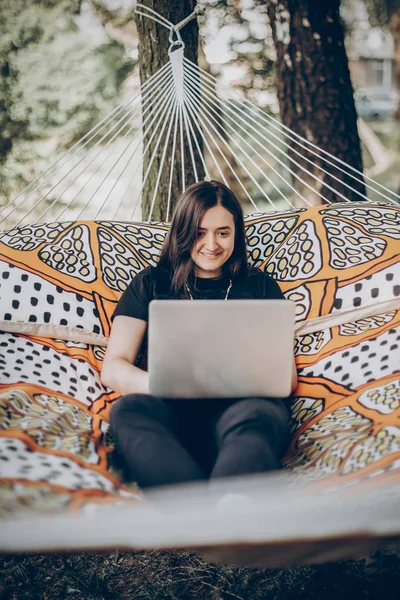 Female freelancer working lying on hammock — Stock Photo, Image