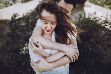 man hugging his woman clipart