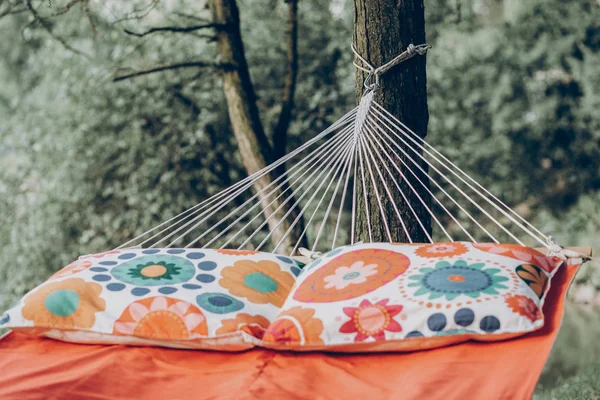 Orange hammock hanging outdoors — Stock Photo, Image