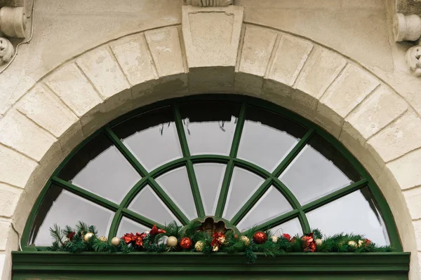 Christmas garland on window — Stock Photo, Image