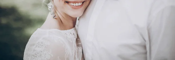 Groom hugging smiling bride — Stock Photo, Image