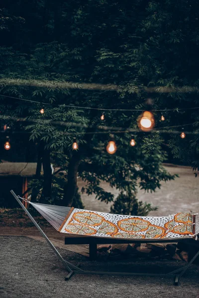 Hammock under romantic lights in park — Stock Photo, Image