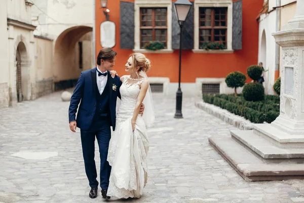 Bride and groom walking outdoors — Stock Photo, Image