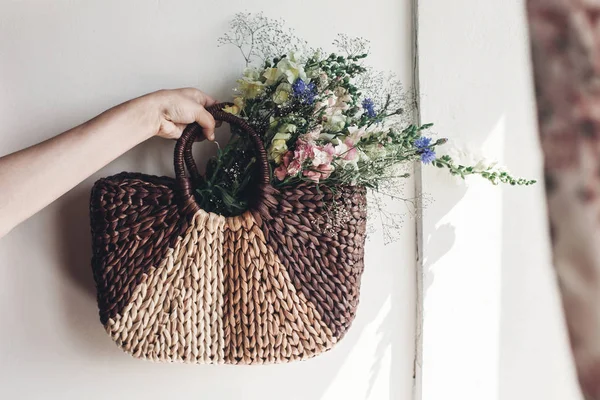 Mano femenina sosteniendo flores silvestres — Foto de Stock