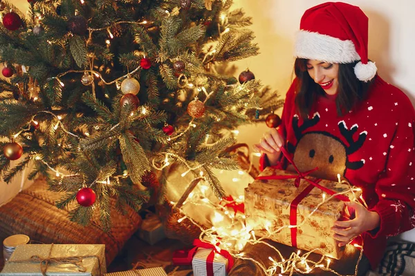 Happy Woman Santa Hat Opening Gift Box Sitting Christmas Tree — Stock Photo, Image