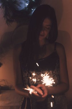 maytap bengal ışık kapalı yanma ile poz gülümseyen esmer kız