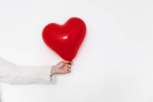 красный шарик в форме сердца в женской руке, изолированный на белом. happy Valentine 's day concept
.
