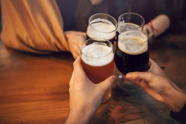 sorun ve lezzetli zanaat bira ile kızartma arkadaşlar çubuk. Grup tezahürat ve barda bir bira zevk insan. bardak bira holding eller. Eğlence ve dostluk kavramı 