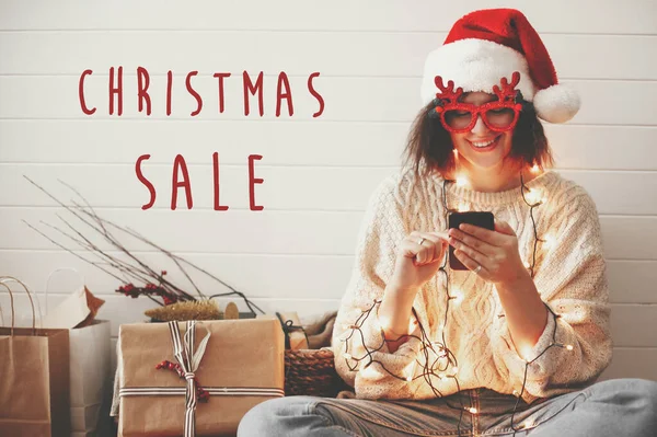 Christmas Sale text sign on stylish happy girl in santa hat look — 스톡 사진