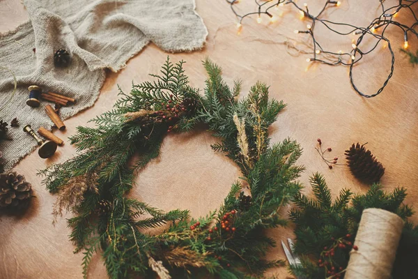 Rustic Christmas wreath. Fir branches, pine cones, thread, berri — Stock Photo, Image