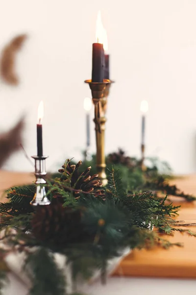 Fir branches with pine cones and vintage candlestick with burnin — Stock Photo, Image