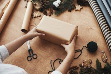 Noel hediyesi paketleme konsepti. Noel hediyesini paketleyen eller 