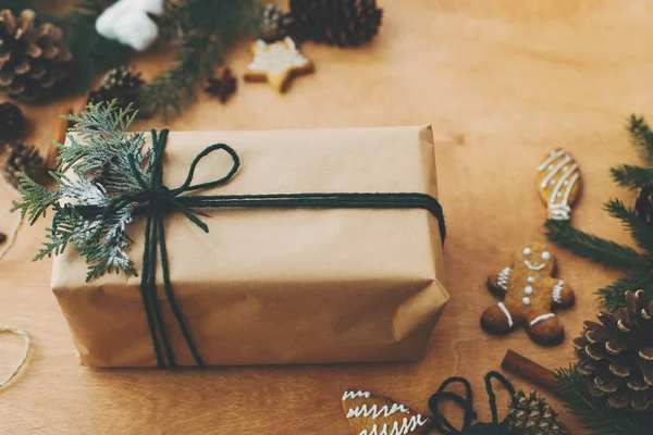 Stylish rustic christmas gifts box with cedar branch on  rural w — Stock Photo, Image