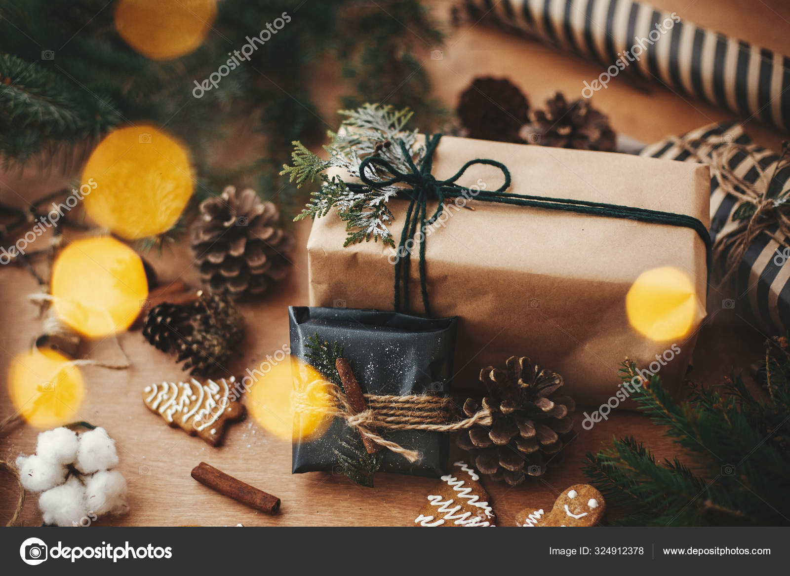 Christmas rustic flat lay. Stylish christmas gift box, wrapping paper,  wooden reindeer Stock Photo by Sonyachny