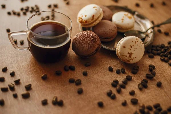 Kaffee in Glasbecher und köstliche Makronenkekse auf Vintagepl — Stockfoto