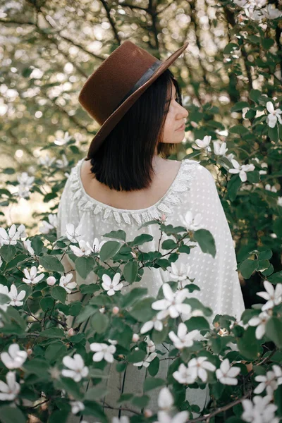 Sensual portrait of beautiful hipster woman in hat smelling  whi — Stock Photo, Image