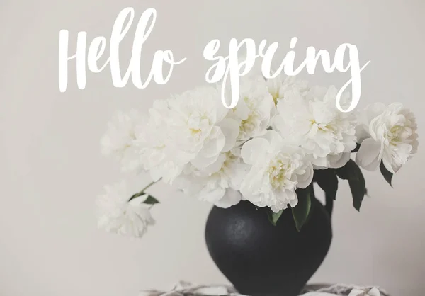 Hello Spring text handwritten on stylish peony bouquet in black — Stock Photo, Image