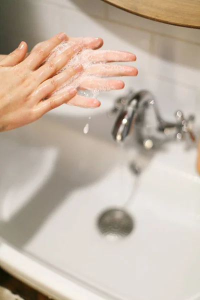 在浴室流动的水的背景上用肥皂泡沫洗手 擦手心 预防流感 个人卫生 洗手以预防大肠病毒的流行 — 图库照片