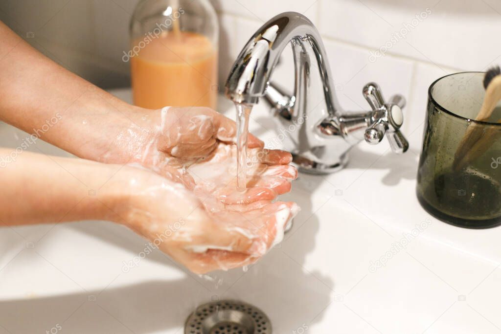 Washing hands. Hands washing with proper technique and antibacterial soap under flowing water in bathroom. Prevent coronavirus epidemic. Prevention of flu disease.
