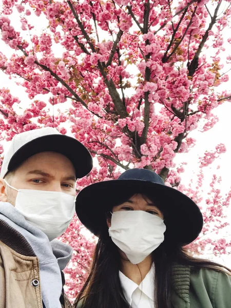 Hipster Couple Face Masks Taking Selfie Background Blooming Sakura Trees — Stock Photo, Image