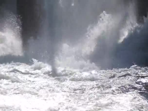 Water boiling in waterfall under old hydropower plant — Stock Video