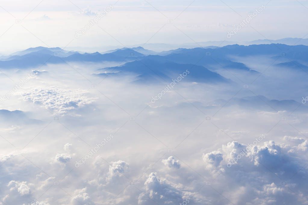Blue sky and mountains view from airplane stylized hipster background with copyspace