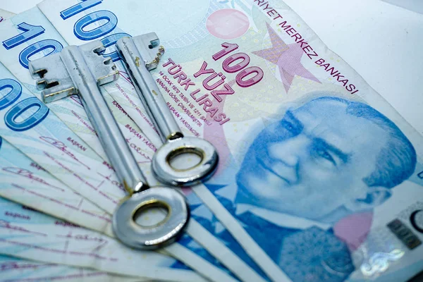 Turkish lira banknotes and keys on isolated background