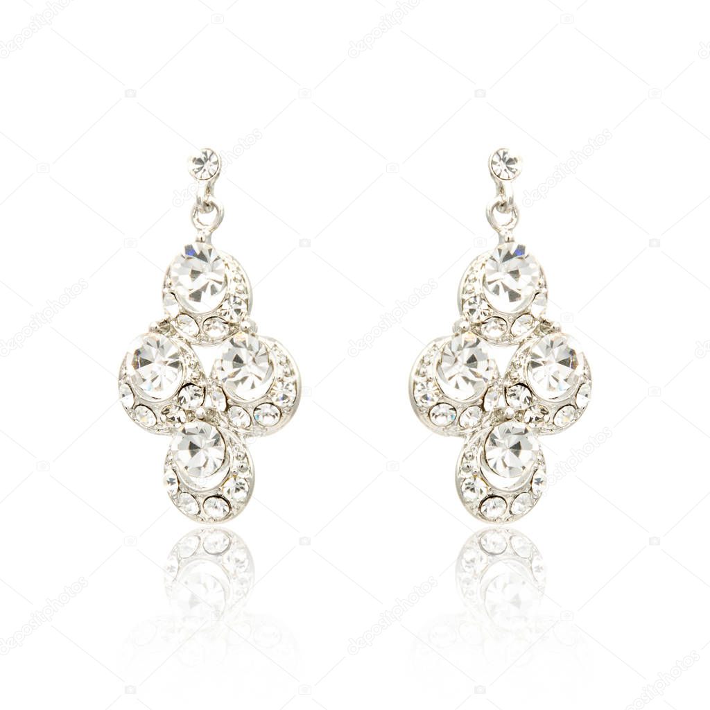 Pair of silver diamond earrings isolated on white