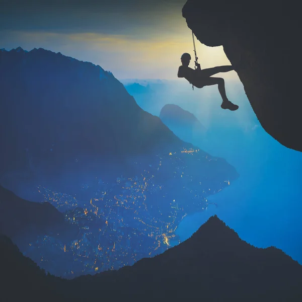 Climber against sunrise above the city. Instagram stylisation — Stock Photo, Image