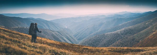 Hiker with big backpack stay on a hill. Instagram stylization — Stock Photo, Image