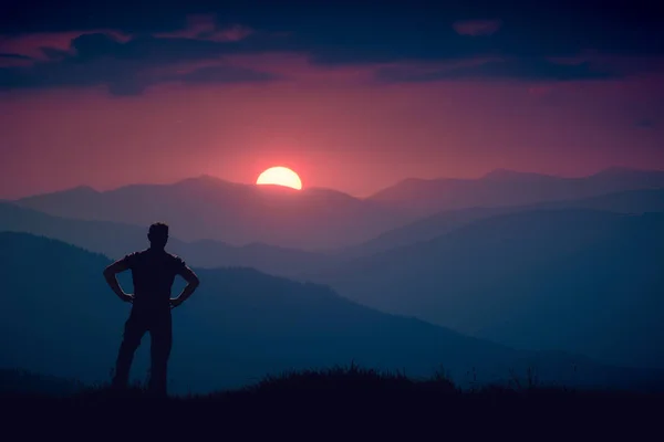 Silhouette of human standing on a hill — Stock Photo, Image