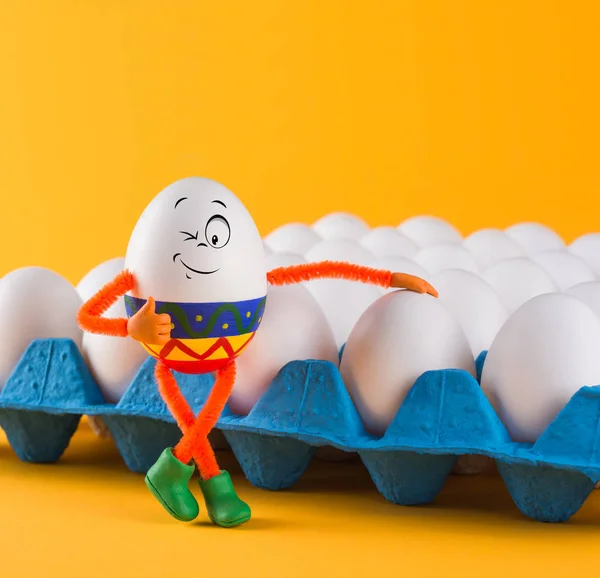 Funny egg boy near the eggs in a tray — Stock Photo, Image