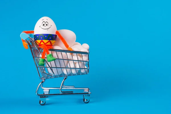 Grappige gelukkig lachend ei zittend op een kar van supermarkt — Stockfoto