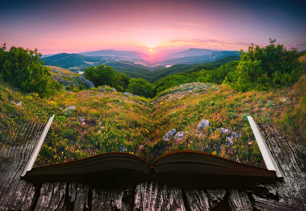 Sunset in a mountain valley on the pages of an open magical book. Majestic landscape. Nature and education concept.