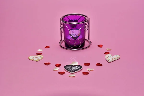 hearts and candle on pink background