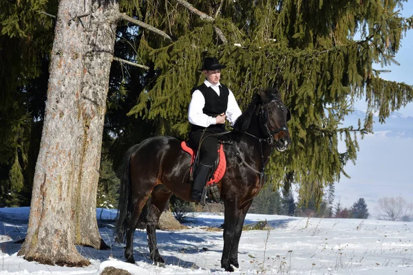 Joven montar a caballo al aire libre en invierno — Foto de Stock