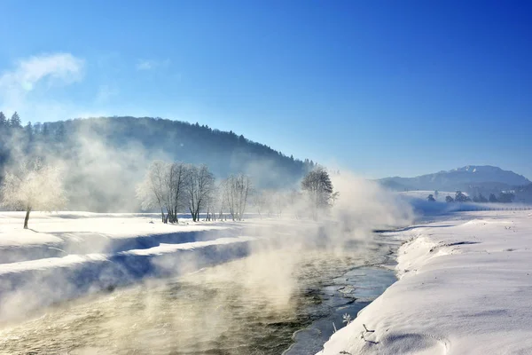 steam above a small river in winter