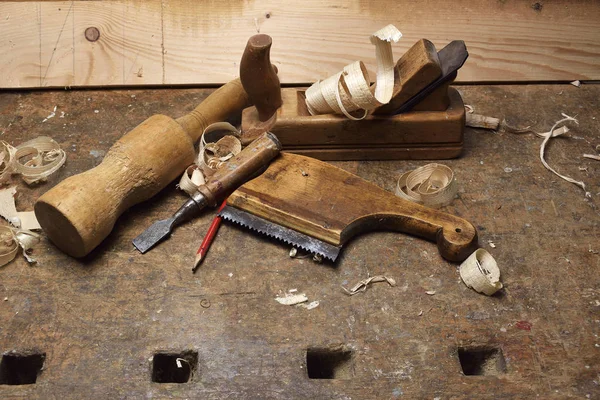 Carpenter tools with wood shaving on wooden table — Stock Photo, Image