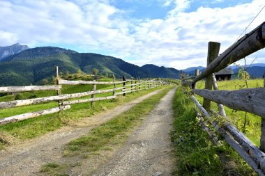 September rural scene in Carpathian mountains. Authentic village and fence clipart