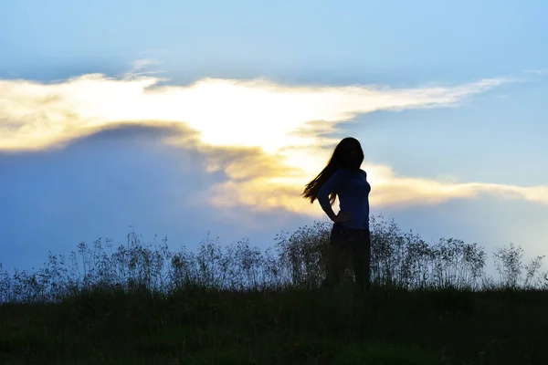 Silhouette di una bella ragazza al tramonto — Foto Stock