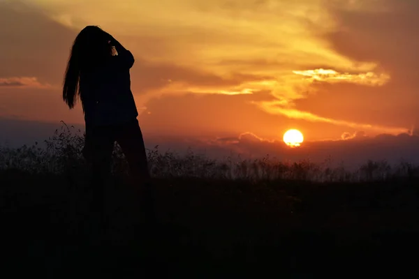 Silhouette di una bella ragazza al tramonto — Foto Stock