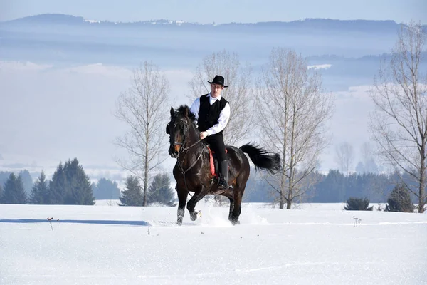 Joven montar a caballo al aire libre en invierno — Foto de Stock