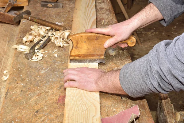 Carpenter with a planer at work in the workshop — Stock Photo, Image