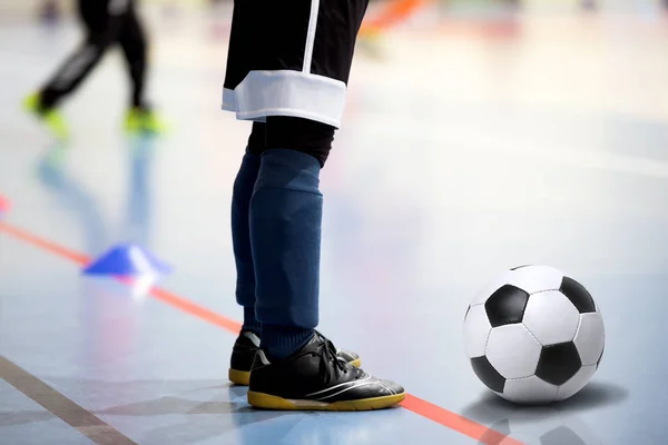 Sessão de treino de futsal. Futsal jogador com bola de futebol. Jovem jogador de futebol com uma bola de futebol em uma sala de esportes. Fundo desportivo — Fotografia de Stock