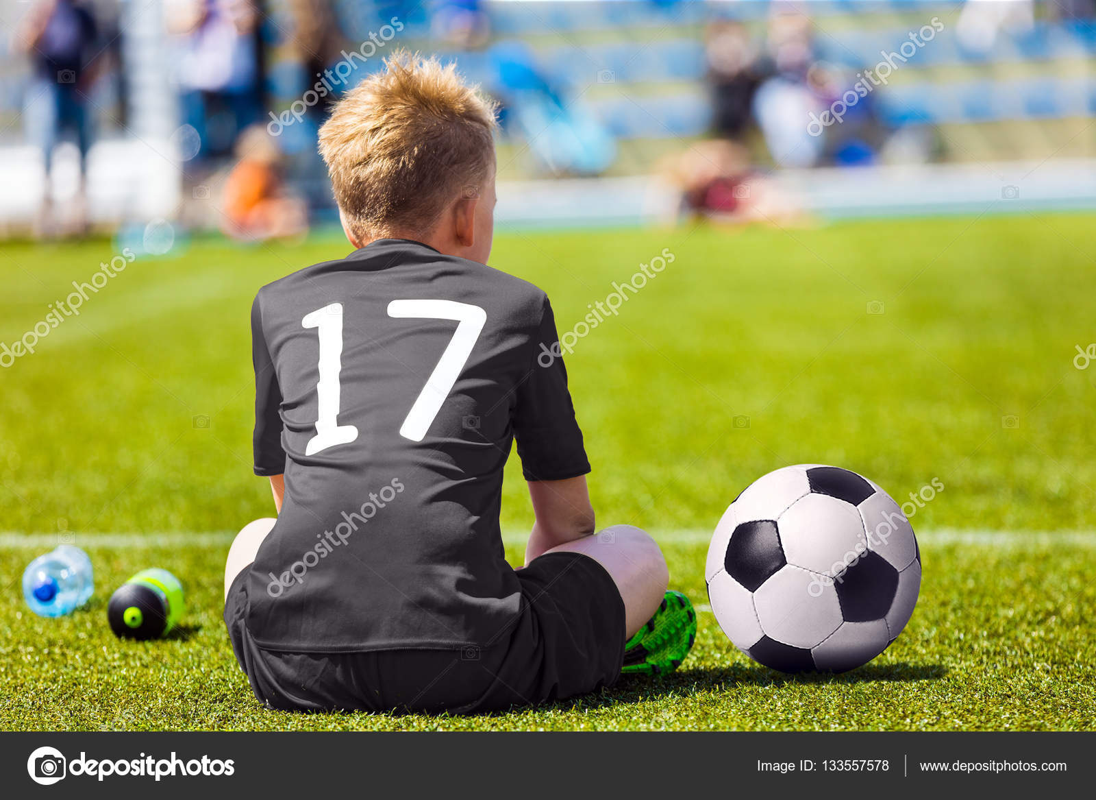 Child In Black Sportswear With Soccer Ball Boy Sitting On Football Pitch School Football Match For Children Stock Photo By C Matimix