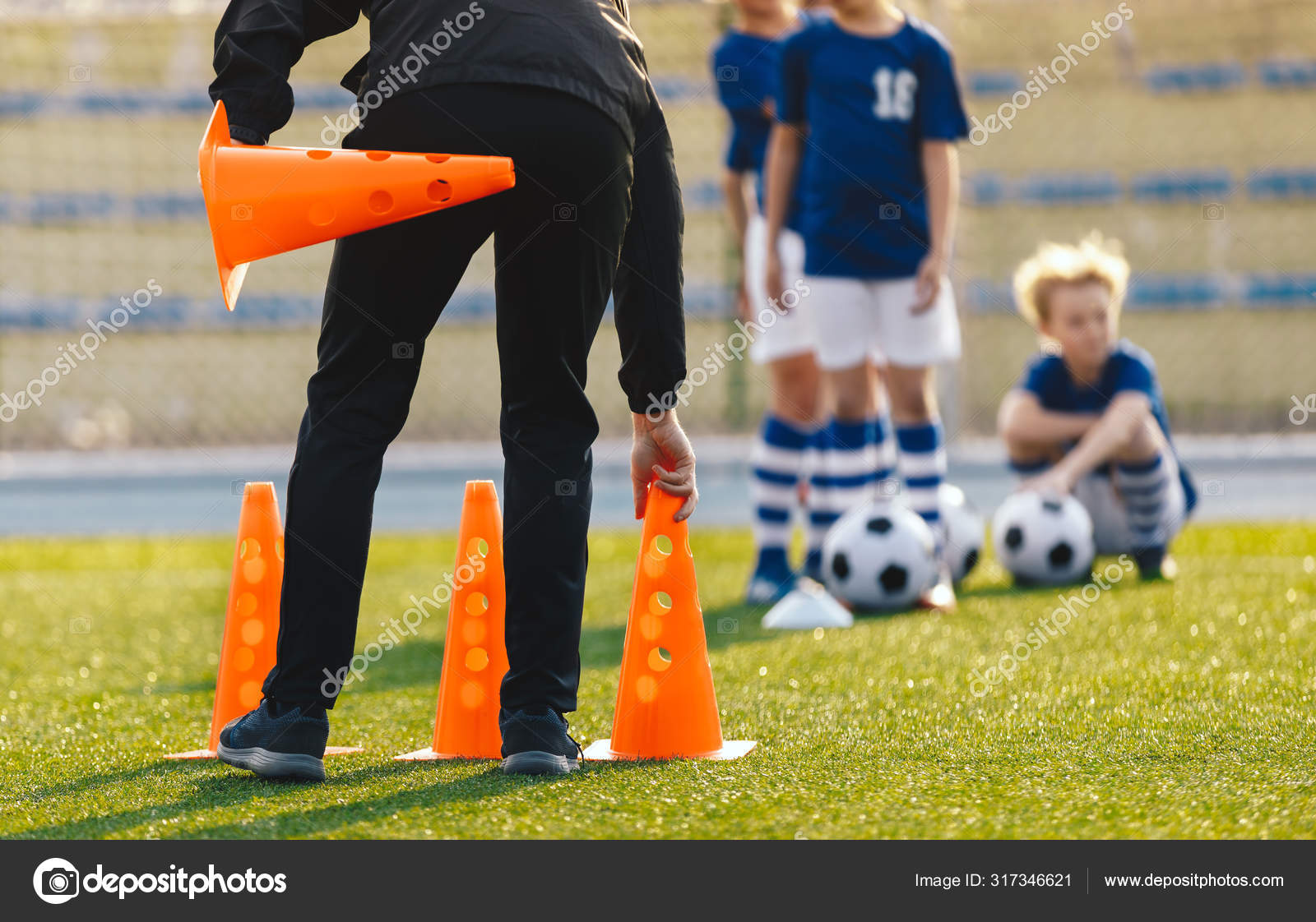 Soccer Coach Placing Training Cones for Kids Sports Team. Children on  Soccer Football Class. Physical Education Soccer Unit Practice on Summer  Sunny Day Stock Photo by ©matimix 317346621