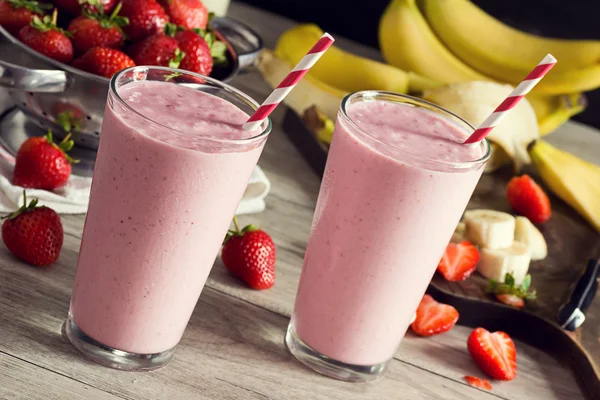Strawberry Banana Fruit Smoothie with Ingredients on Table